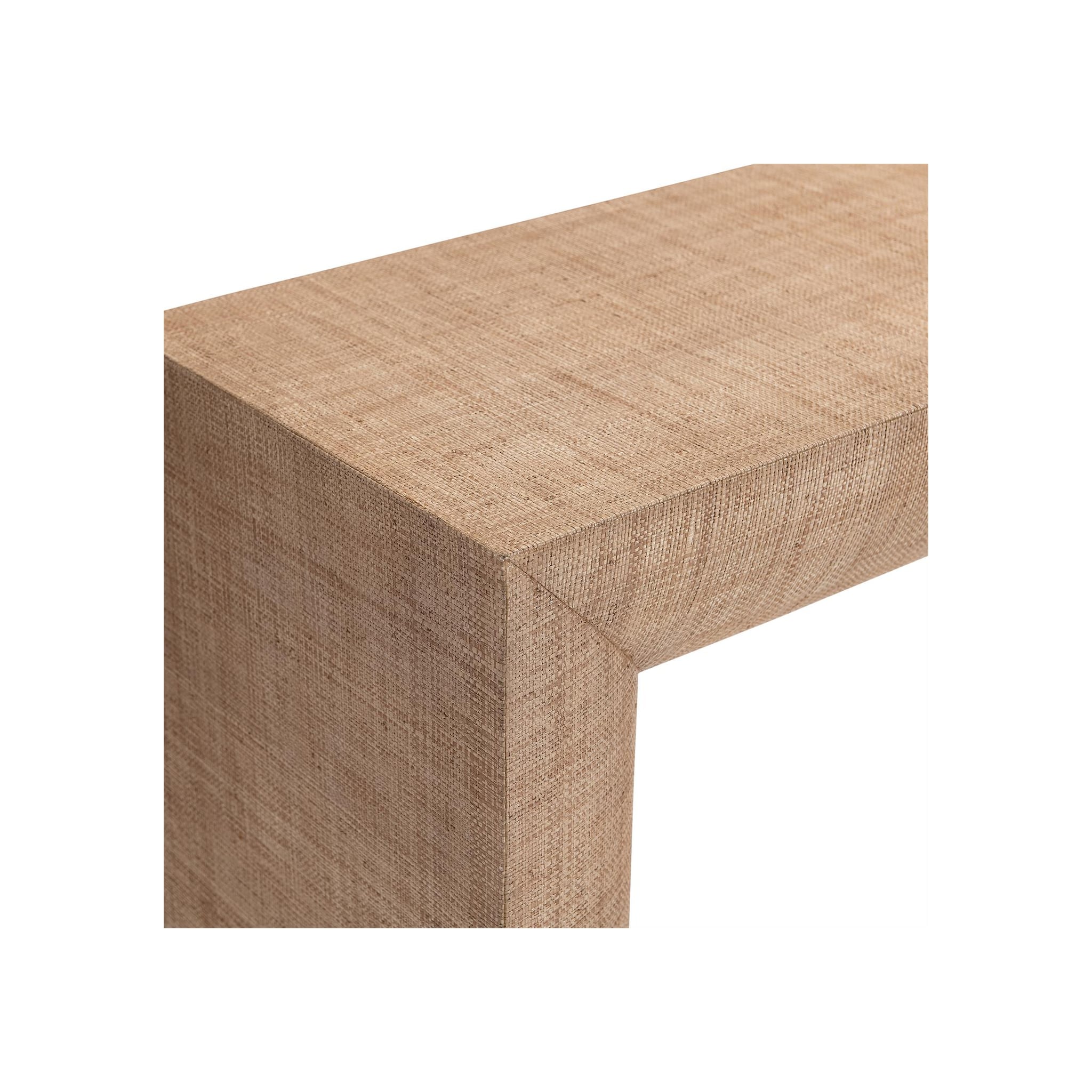 Console table corner detail, natural tan woven grasscloth-wrapped surface, close-up angle