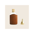 Glass flask in tan leather sleeve with brass knurled cap and small brass funnel accessory