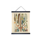 Vintage bird feather chart print in black magnetic wood hanger frame, hanging on white background