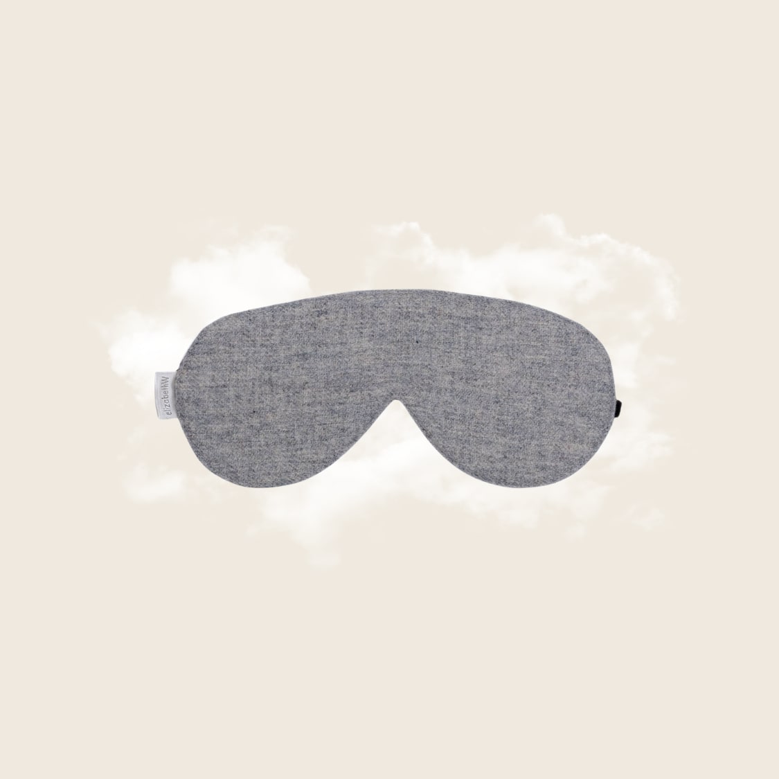 Sleep mask in heather gray wool fabric, front-facing flat lay on cloud prop