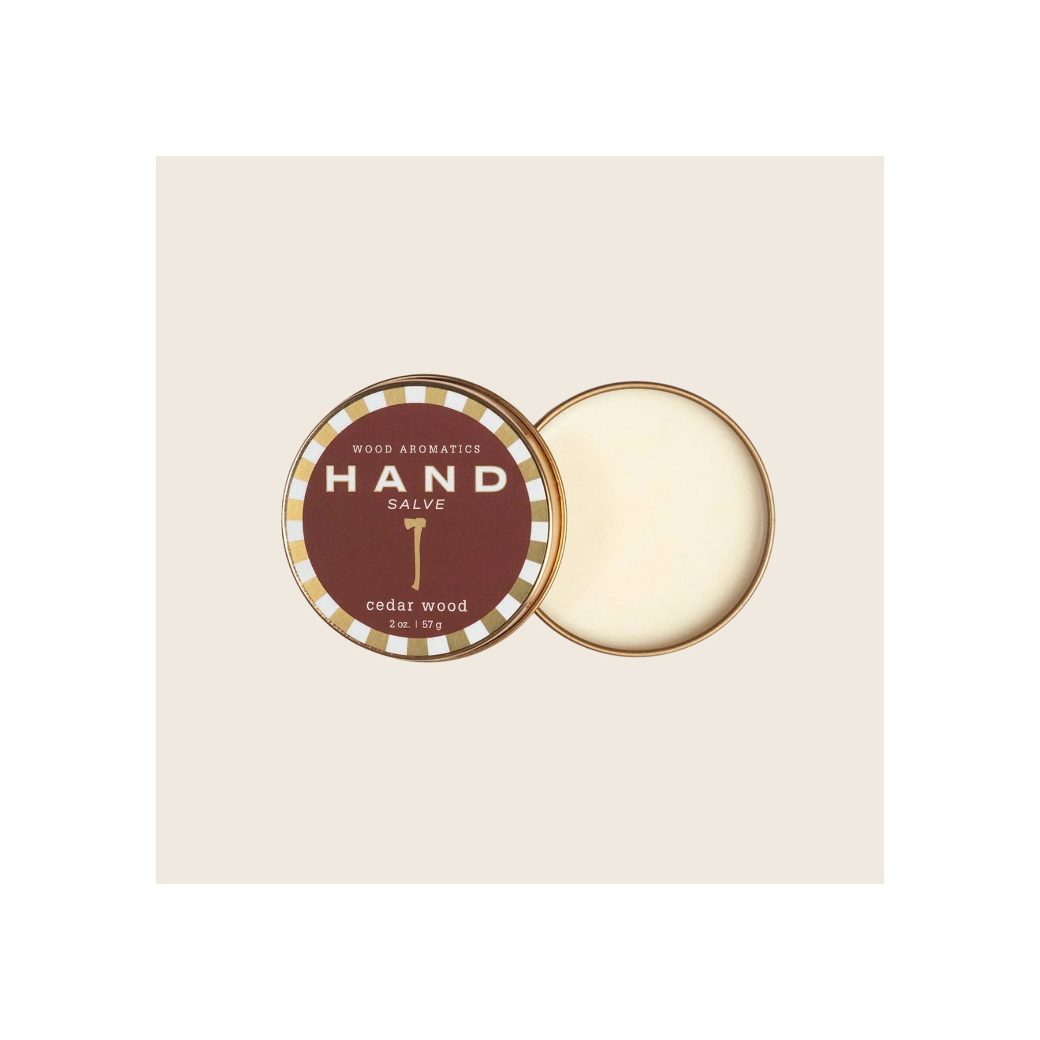 Hand salve tin, open, gold and burgundy label, cream-colored product visible