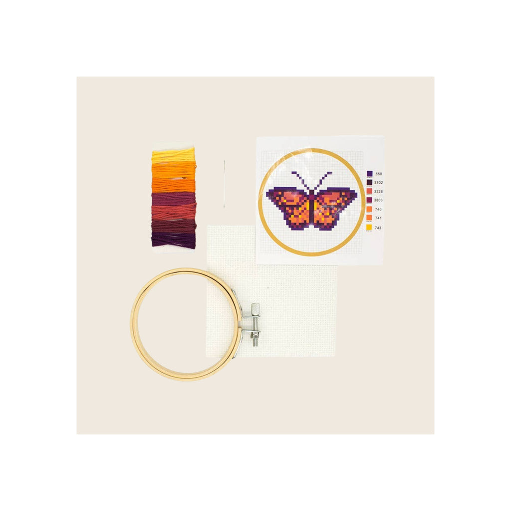 Cross stitch embroidery kit with butterfly pattern card, wooden hoop, aida fabric, and multicolor thread skeins