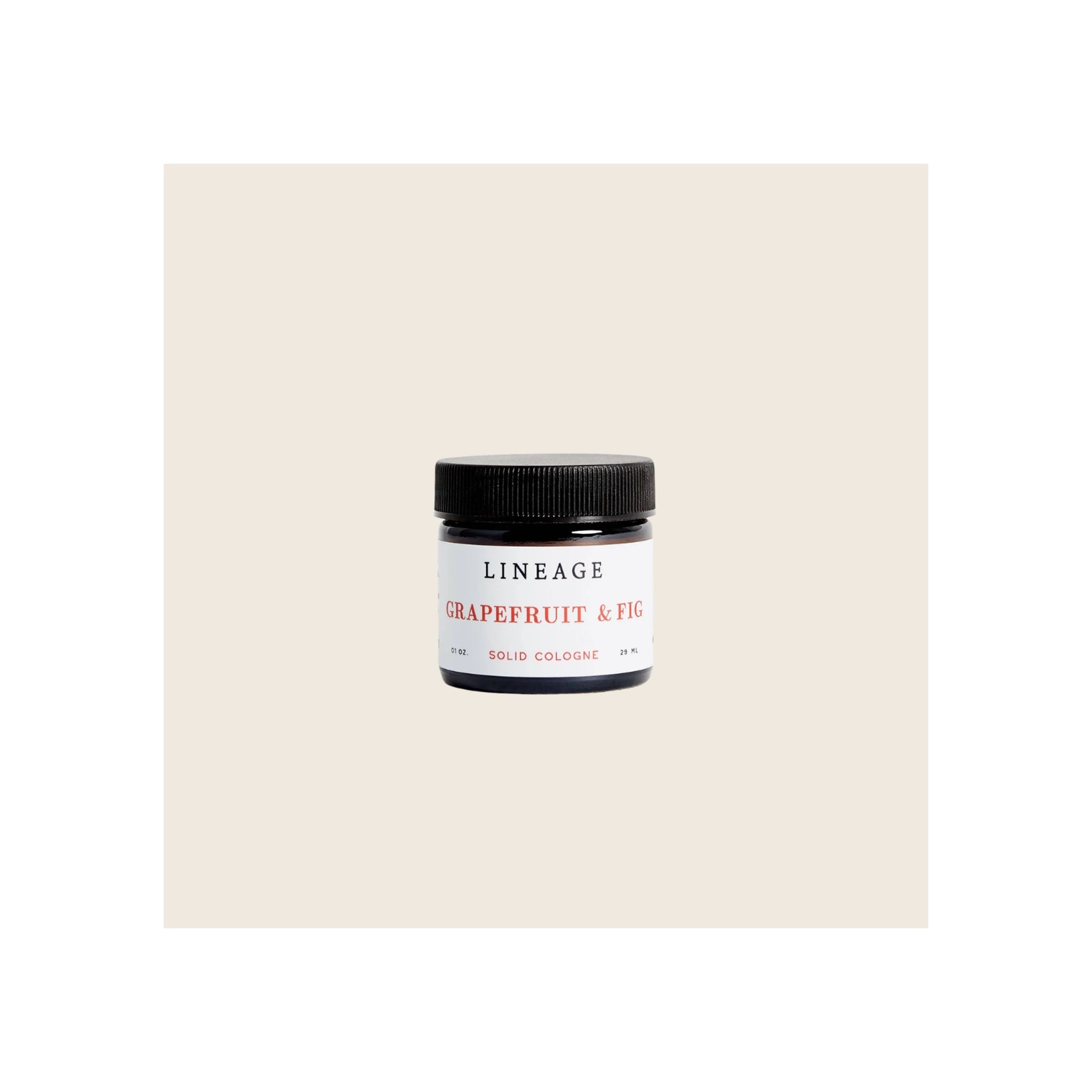 Solid cologne jar, amber glass with black screw-top lid, white label, front-facing upright