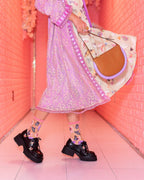 Sheer crew socks with pink cuff, butterfly and sunflower print, worn with black chunky platform shoes
