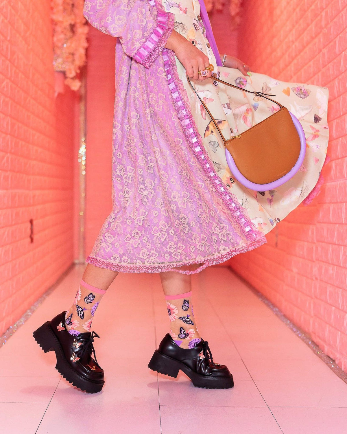 Sheer crew socks with pink cuff, butterfly and sunflower print, worn with black chunky platform shoes