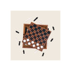 Wooden chess and checkers game set, two stacked boards top-down view, black and white pieces scattered around
