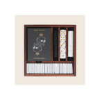 Wooden games compendium box open top-down, containing skull-design playing cards, white and black poker chips, and white dice with gold pips
