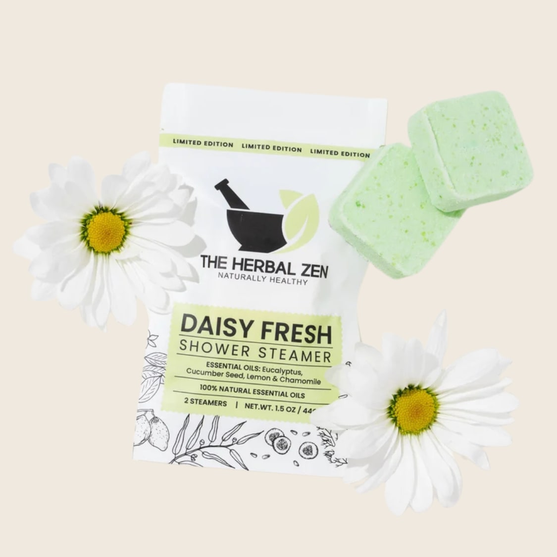 Shower steamer pouch with two green square tablets and white daisy flowers on beige background