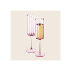 Champagne flutes set of two pink tinted glass with scalloped rims one filled with sparkling wine
