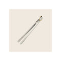 Indian tongs, polished stainless steel with gold-tone brass ring, diagonal orientation