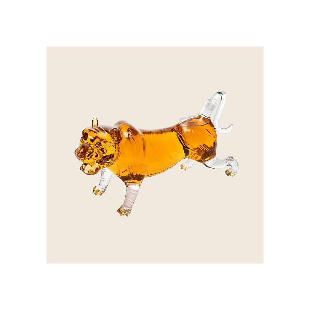 Tiger-shaped glass decanter filled with amber whiskey, clear glass legs and tail, stopper at tail, side profile view
