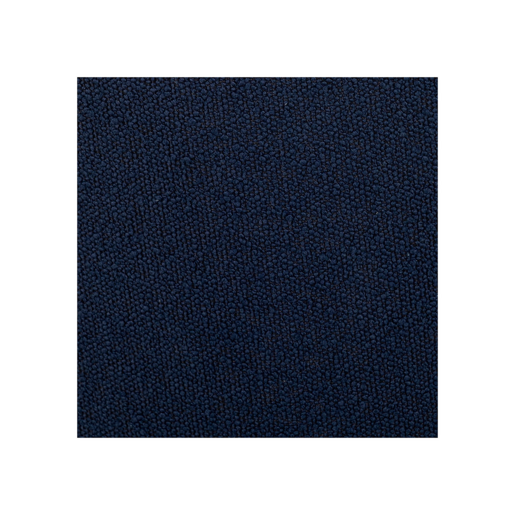 Macro fabric swatch of deep navy bouclé showing dense nubby looped texture and rich blue tone