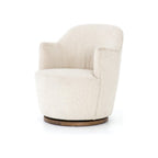 Swivel accent chair in cream bouclé upholstery with parawood base shown in three-quarter view, alternate colorway
