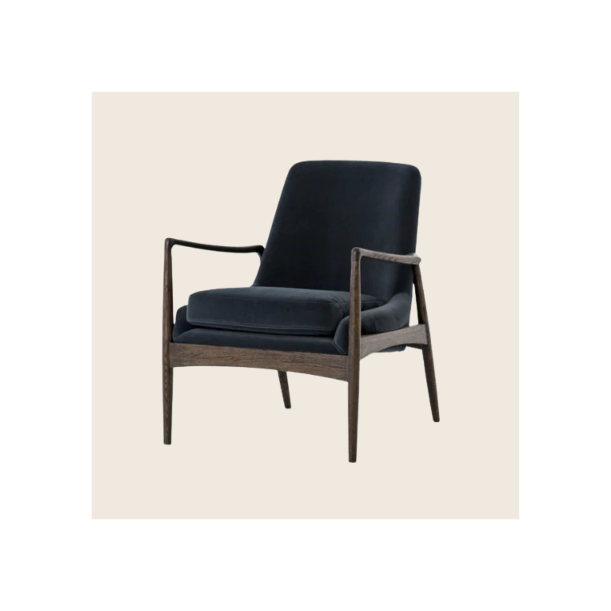 Armchair with dark navy velvet upholstery, dark walnut-finish wood frame, angled three-quarter view