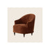 Armchair in rust-brown velvet with button-tufted back, curved barrel silhouette, dark turned wood legs, angled three-quarter view