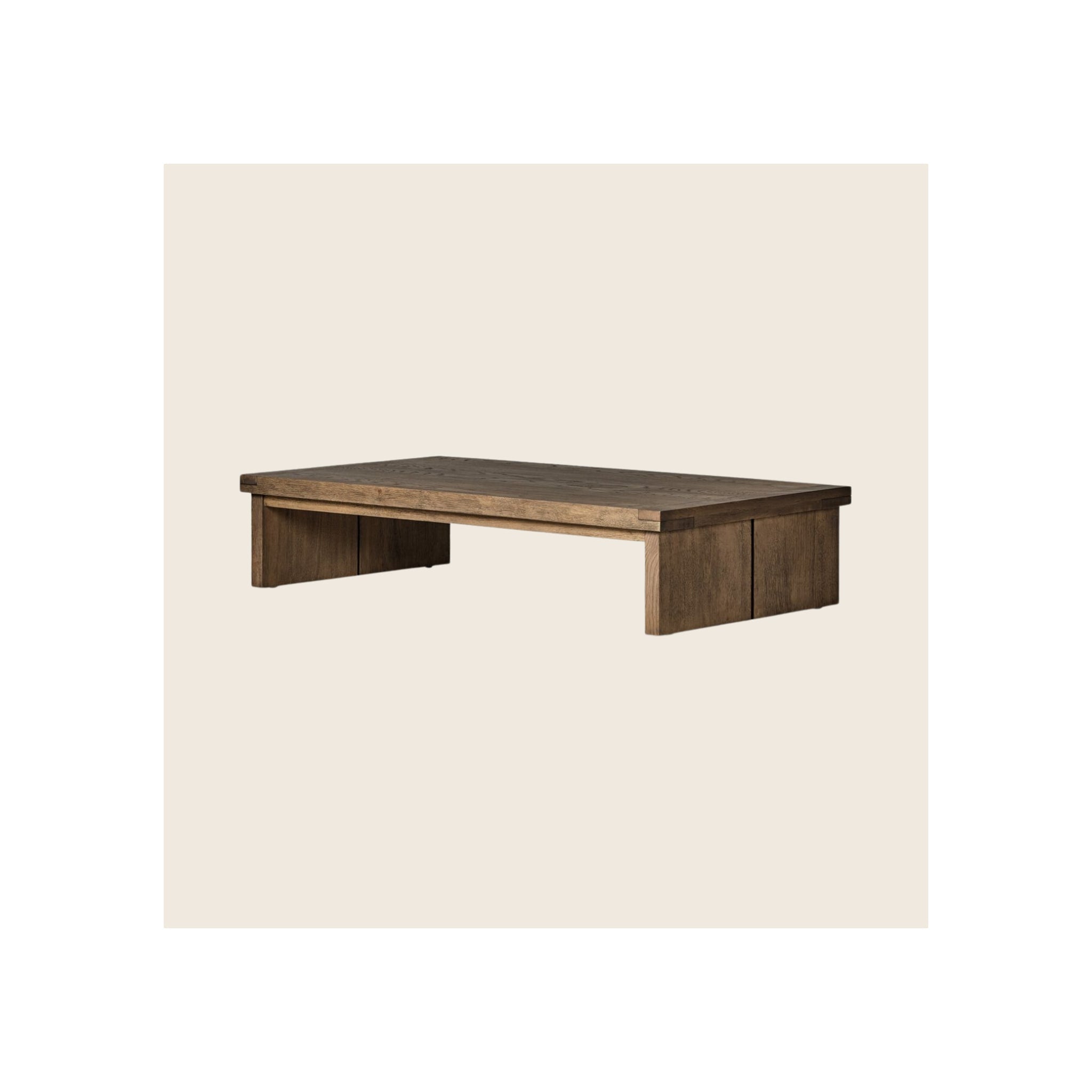 Coffee table in dark brown reclaimed wood finish, low-profile rectangular silhouette, panel legs