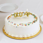 Gold balloon-letter "OLD AF" birthday candles lit on white frosted cake with rainbow sprinkles