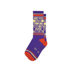 Crew socks in purple, red, and yellow with bold knitted text on cuff, flat lay pair