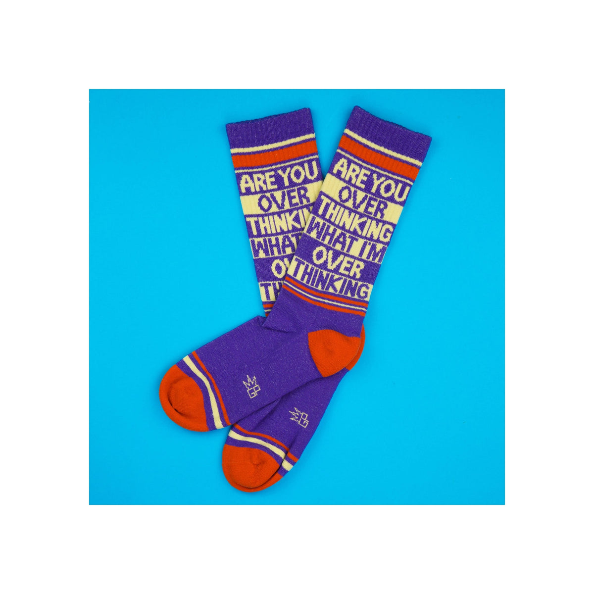 Socks, purple knit crew length with red-orange heel and toe, cream and red stripes, bold text graphic