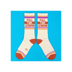 Crew socks, cream with orange, purple, and pink stripes, "Full Time Lesbian" knit text, rust toe and heel, flat lay pair