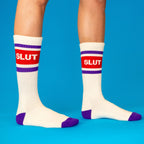 Crew socks white with purple stripes red box and SLUT text worn on legs
