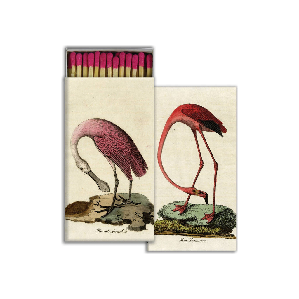 Two decorative matchboxes, cream with vintage bird illustrations, pink-tipped matches visible