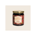 Glass jar of bourbon-infused boozy cherries, gold metal lid, dark red label, upright front view