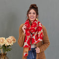 Scarf, red and beige large poppy print, reversible wrap style, draped around model's neck