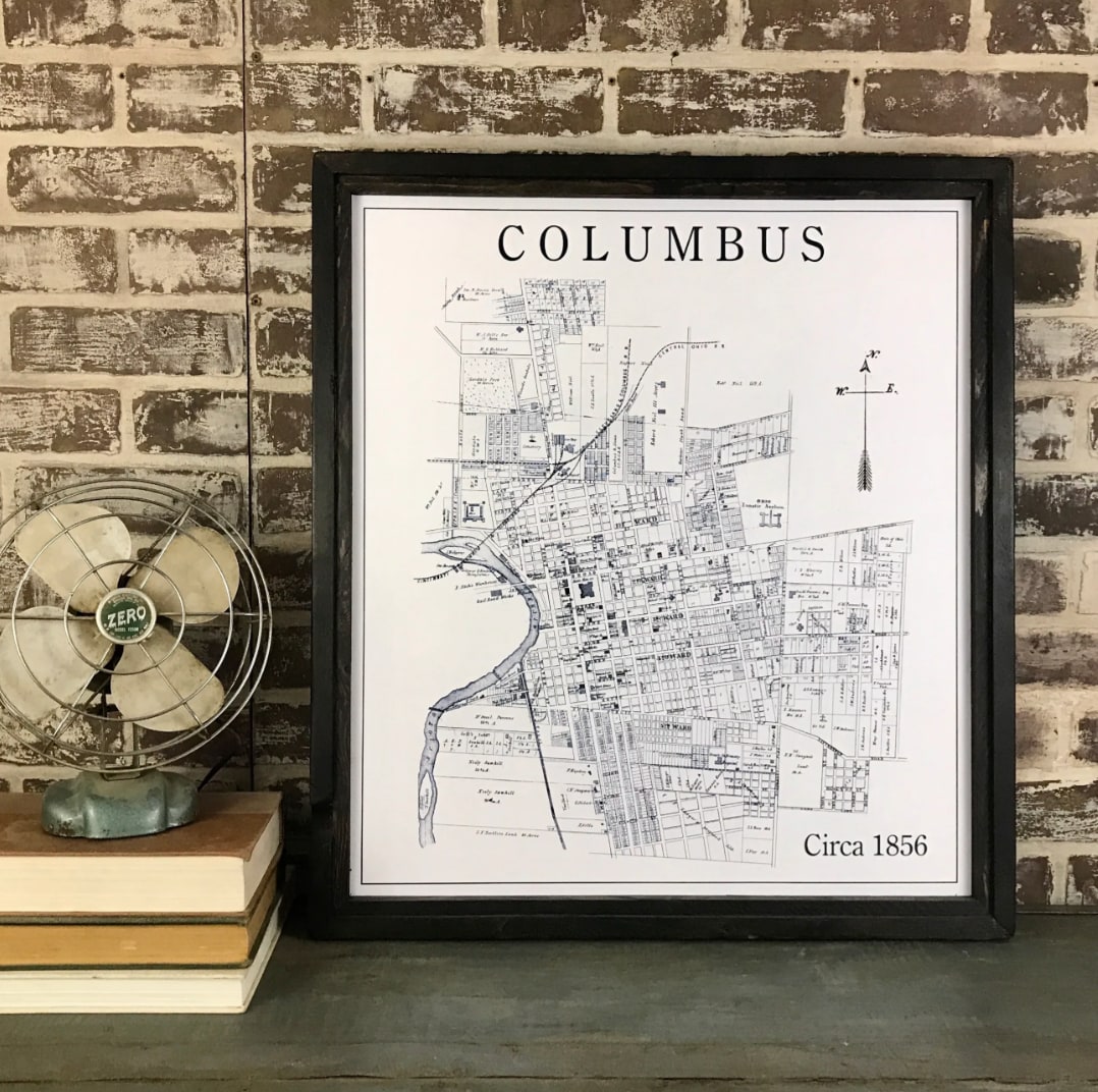 Framed Columbus 1856 vintage map print, black wood frame, displayed upright on shelf