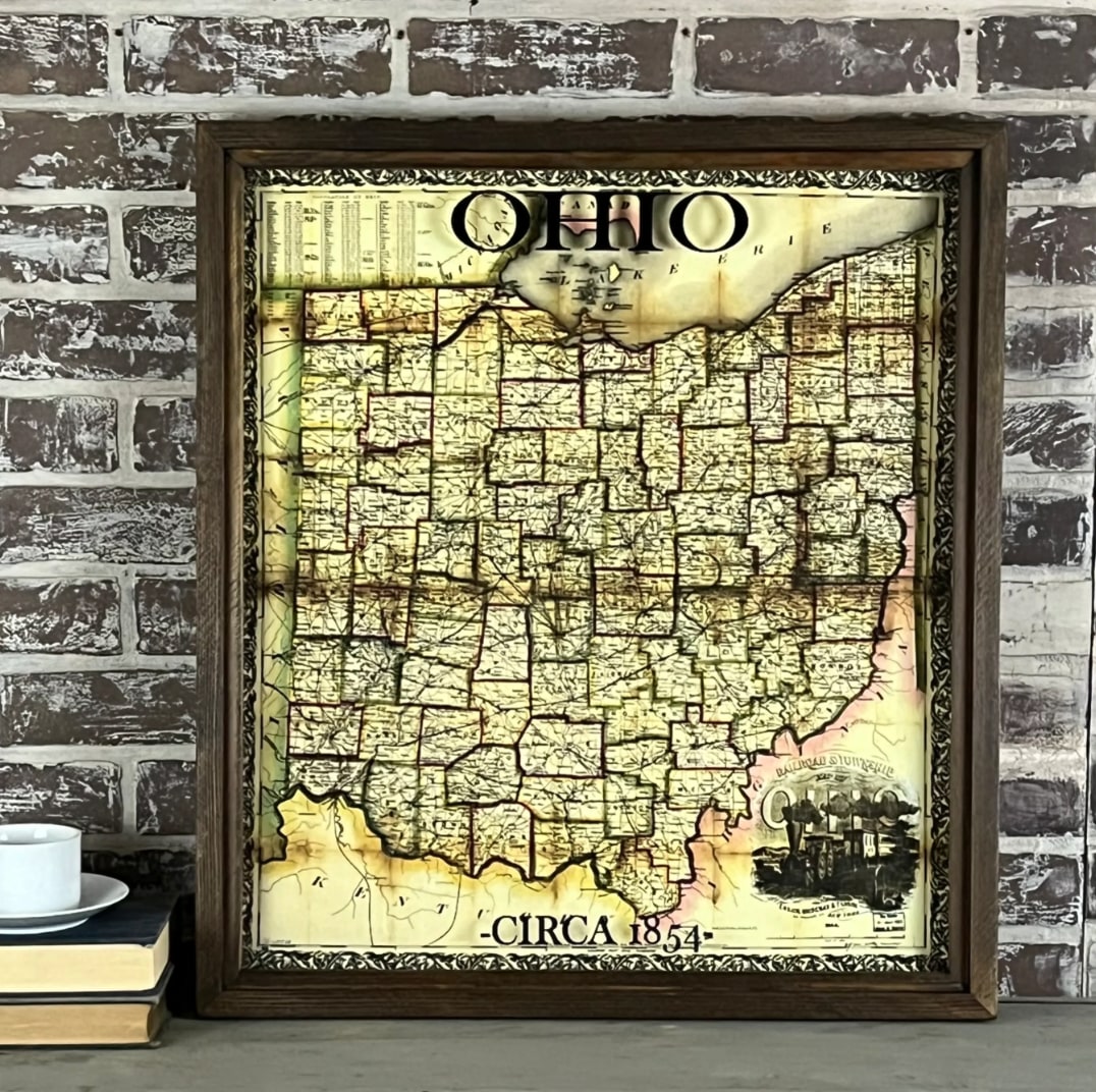 Framed Ohio 1854 vintage map, dark walnut wood frame, aged sepia tones, upright on shelf