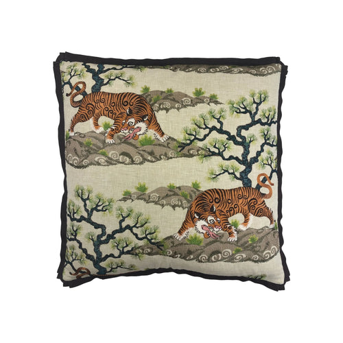 Cushion with embroidered tigers, pine trees, and hills on natural linen ground with black fringe trim
