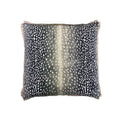 Throw pillow, navy and white deer-spot print, square with fringe trim, flat lay