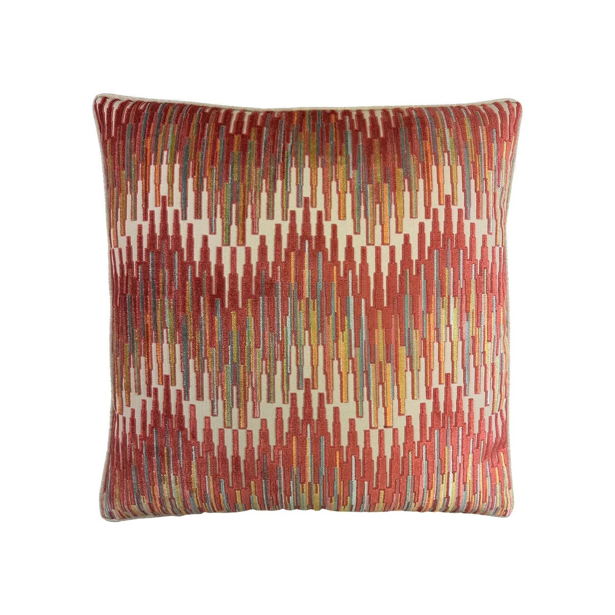 Throw pillow with multicolor geometric ikat pattern in red, orange, yellow, teal, and cream tones