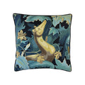 Cushion with tapestry-style woven otter amid teal and navy botanical foliage, black piped border