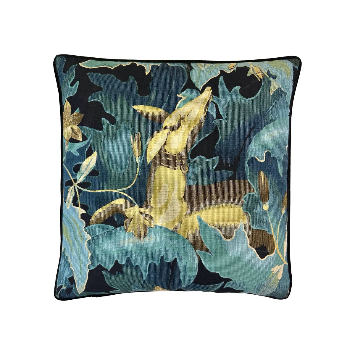 Cushion with teal and navy tapestry-weave deer-and-foliage pattern, black piped border, square format