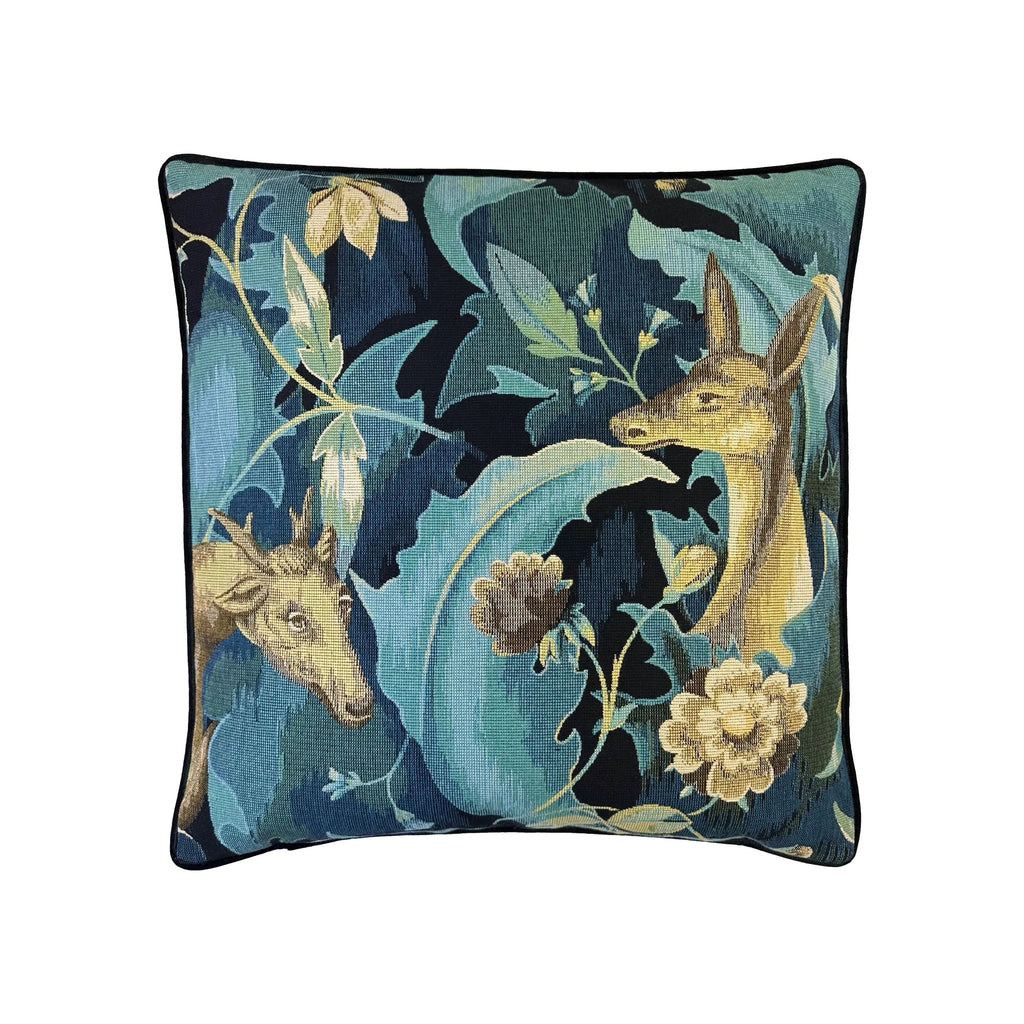 Cushion with teal and navy tapestry print featuring deer and floral motifs, black piped border, square format