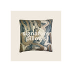 Throw pillow with abstract marble swirl print in teal, gold, brown, and cream tones, front view