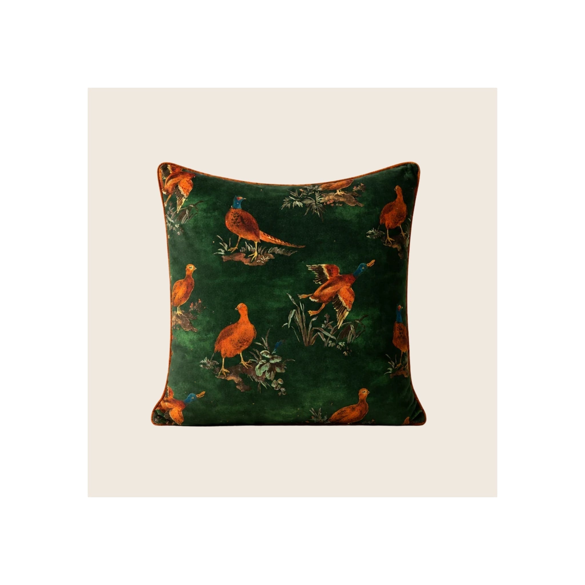 Cushion in dark emerald green velvet with orange pheasant and duck print, rust piped edging, square format, front-facing
