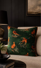 Cushion, dark emerald green velvet with orange pheasant and duck print, orange piped trim, styled on beige sofa