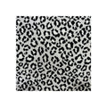 Fabric swatch close-up, black and white leopard-print woven textile, flat lay