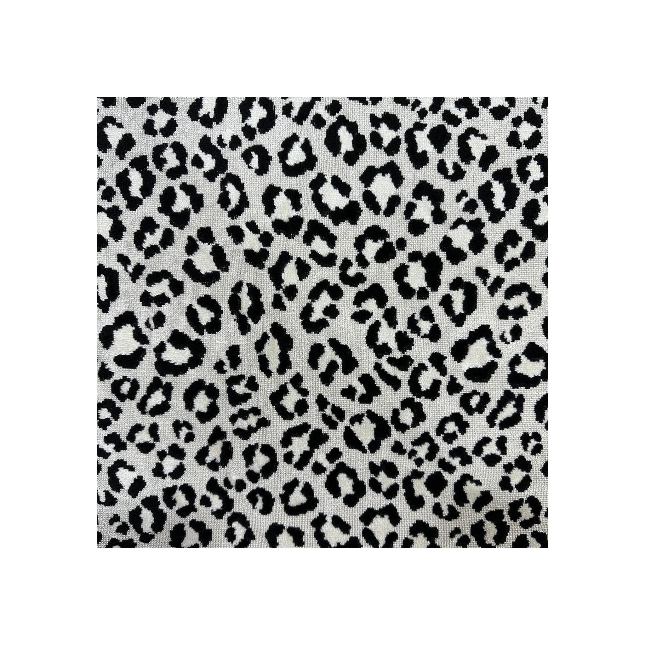 Fabric swatch close-up, black and white leopard-print woven textile, flat lay