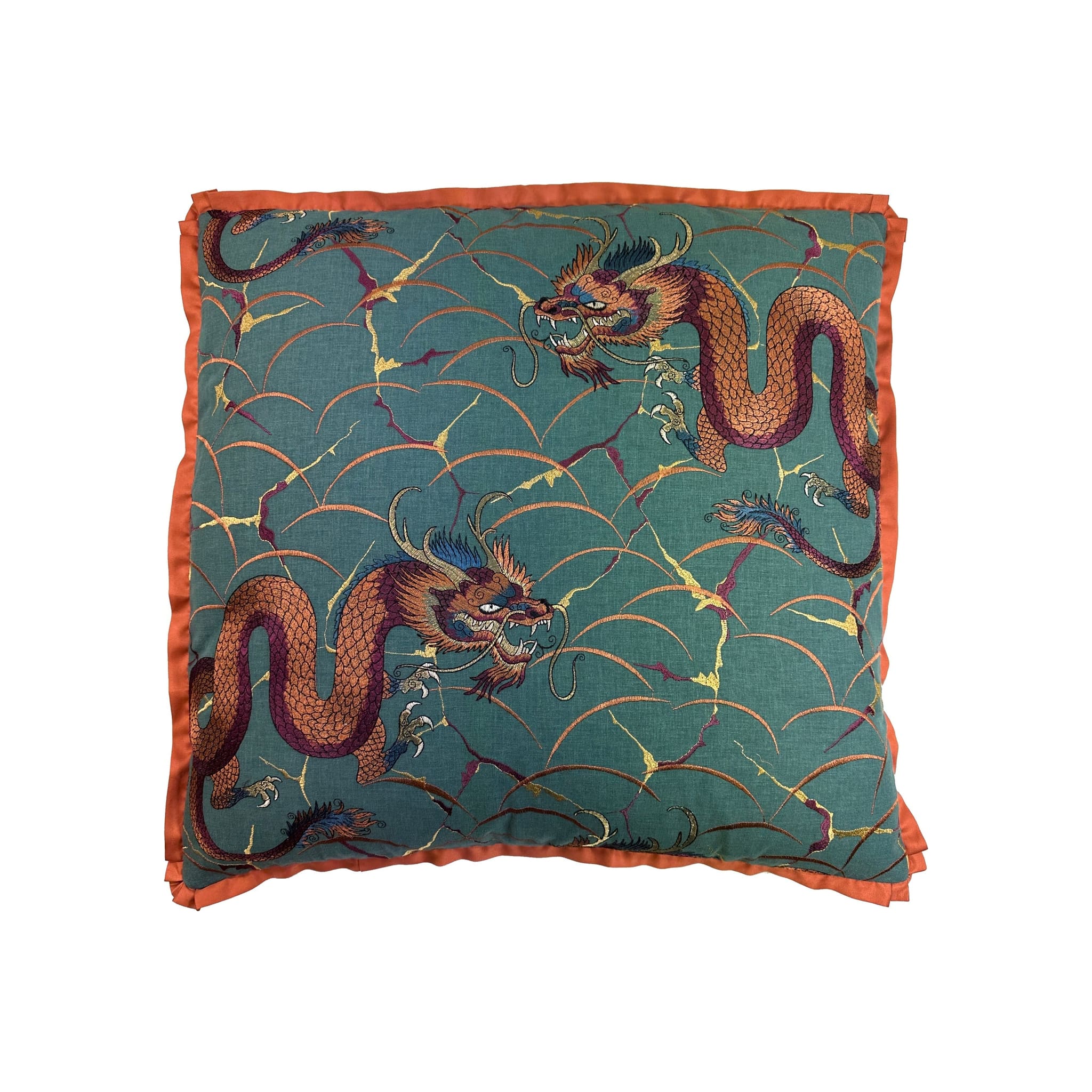 Cushion with teal dragon-print fabric, orange satin border trim, square format, flat lay