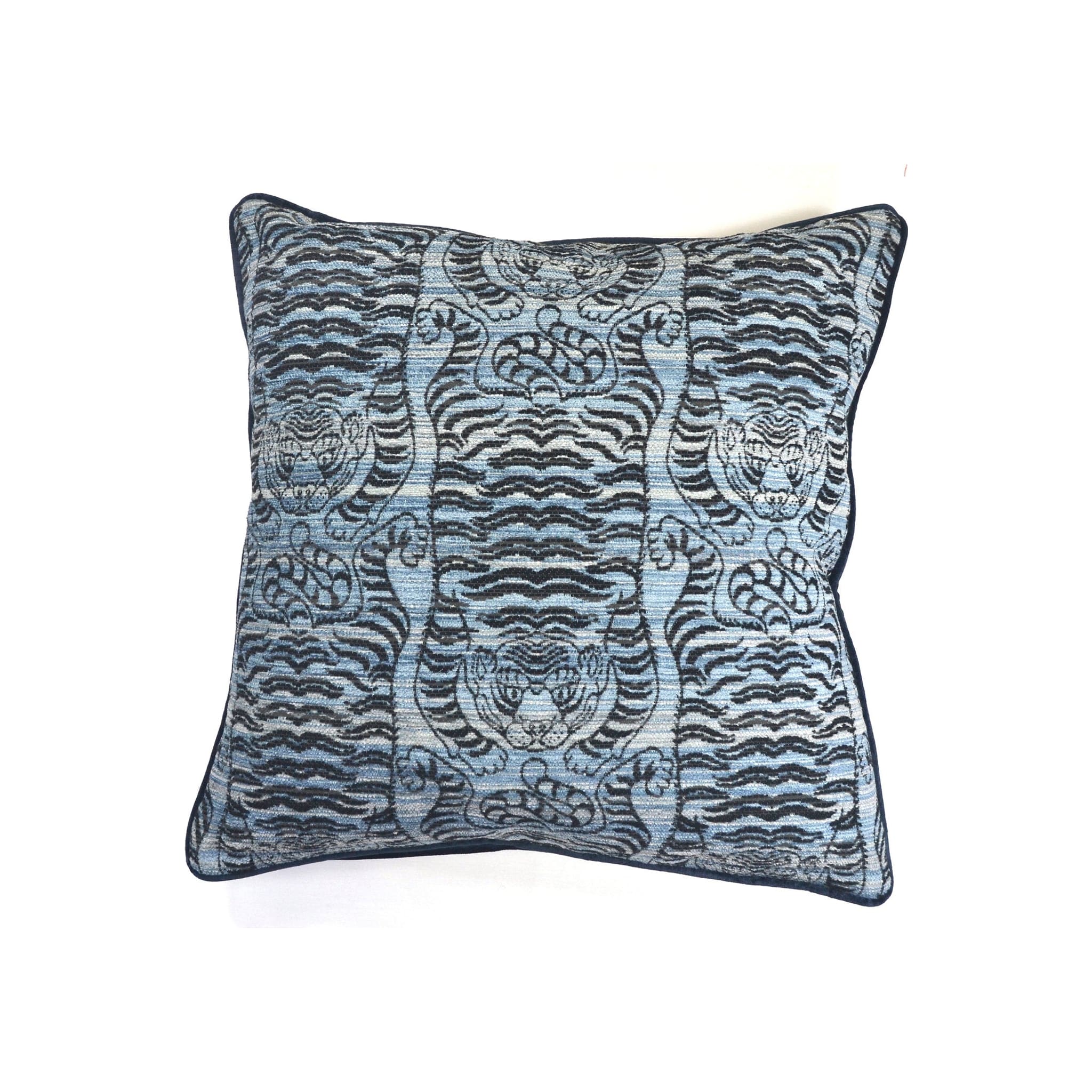 Cushion with blue and black woven tiger motif pattern and navy piped border