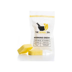 Shower steamer 2-pack in white resealable pouch, yellow lemon-scented square tablets displayed in front
