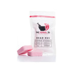 Shower steamer 2-pack in white resealable pouch with two pink tablet steamers placed in front