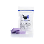 Shower steamer two-pack in white resealable pouch with two purple square tablets in front