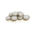 Cluster of eight small bowls, gold exterior with white glazed interior, varied sizes, top-angle view