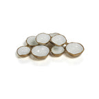 Cluster of eight small bowls, gold exterior with white glazed interior, varied sizes, top-angle view